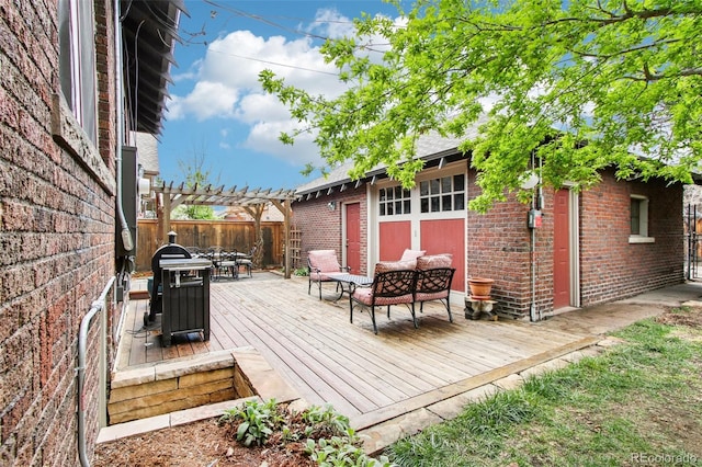 wooden deck with a pergola, fence, and outdoor dining area