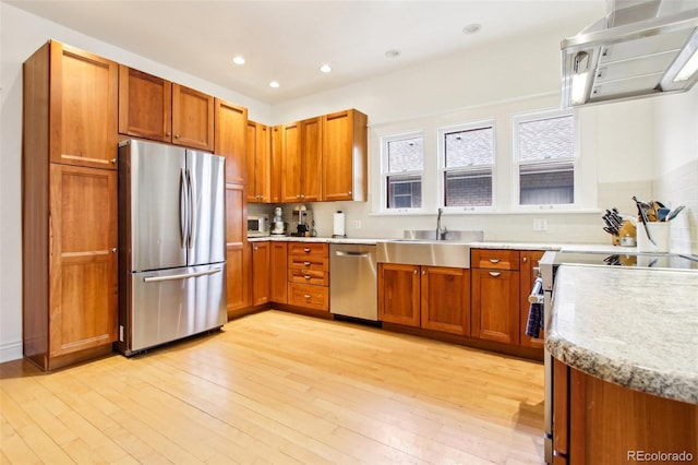 4253 Hooker St, Denver, CO 80211 - kitchen with appliances with stainless steel finishes, brown cabinets, a sink, light wood-style floors, and recessed lighting