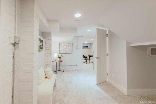 hallway featuring light colored carpet