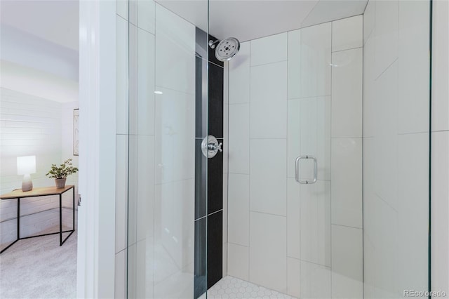 bathroom featuring a shower with door