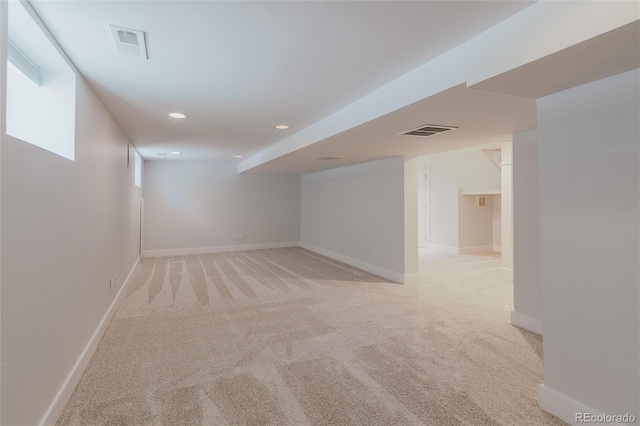 basement featuring light colored carpet