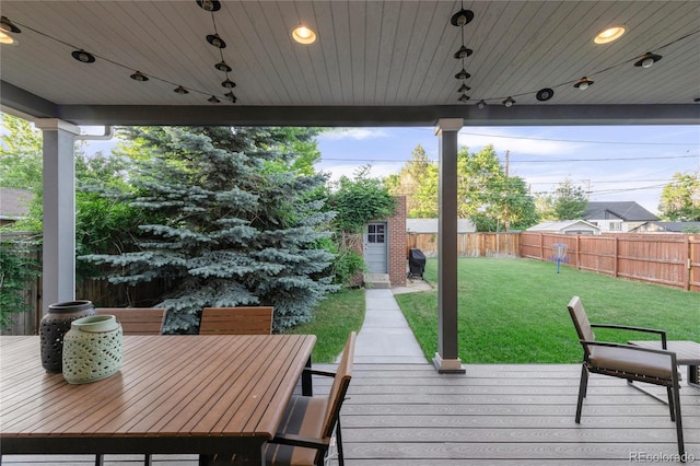 wooden terrace featuring a yard