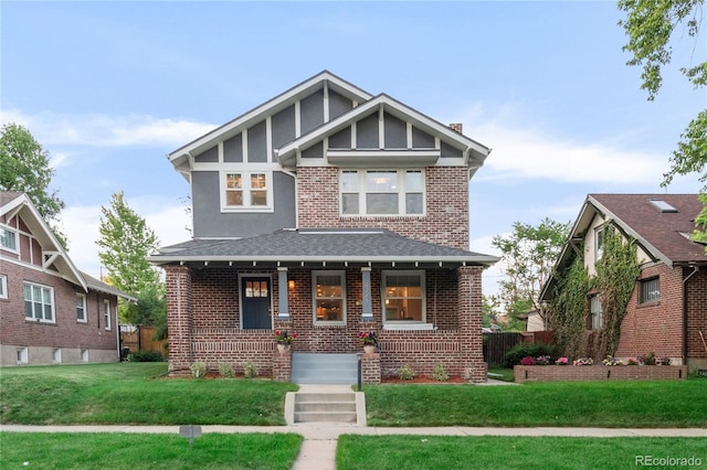 view of front of house with a porch and a front yard