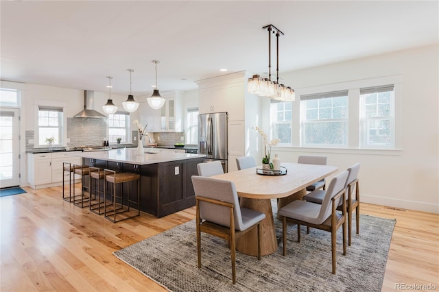 dining room featuring sink and light wood-type flooring