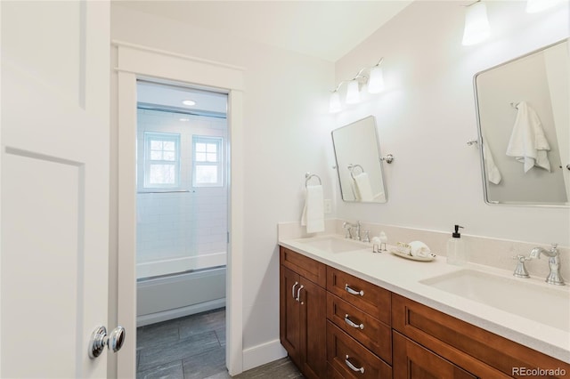 bathroom with combined bath / shower with glass door and vanity