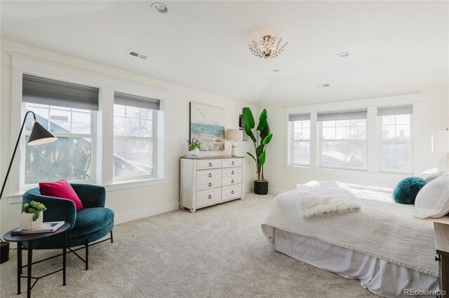 bedroom featuring light colored carpet, lofted ceiling, and multiple windows