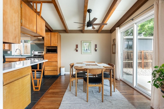 7820 Grove St, Westminster, CO 80030 - dining area featuring healthy amount of natural light, beam ceiling, ceiling fan, and dark wood-style flooring