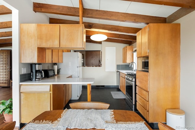 7820 Grove St, Westminster, CO 80030 - kitchen with appliances with stainless steel finishes, light countertops, a peninsula, and light brown cabinets