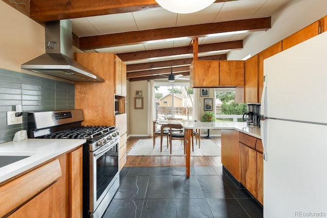 7820 Grove St, Westminster, CO 80030 - kitchen with freestanding refrigerator, stainless steel gas stove, island range hood, decorative backsplash, and ceiling fan