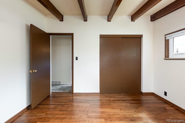 7820 Grove St, Westminster, CO 80030 - unfurnished bedroom featuring a closet, wood finished floors, and beamed ceiling