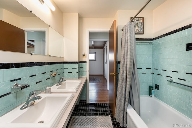 7820 Grove St, Westminster, CO 80030 - bathroom featuring tile walls, shower / bath combination with curtain, tile patterned floors, a wainscoted wall, and double vanity