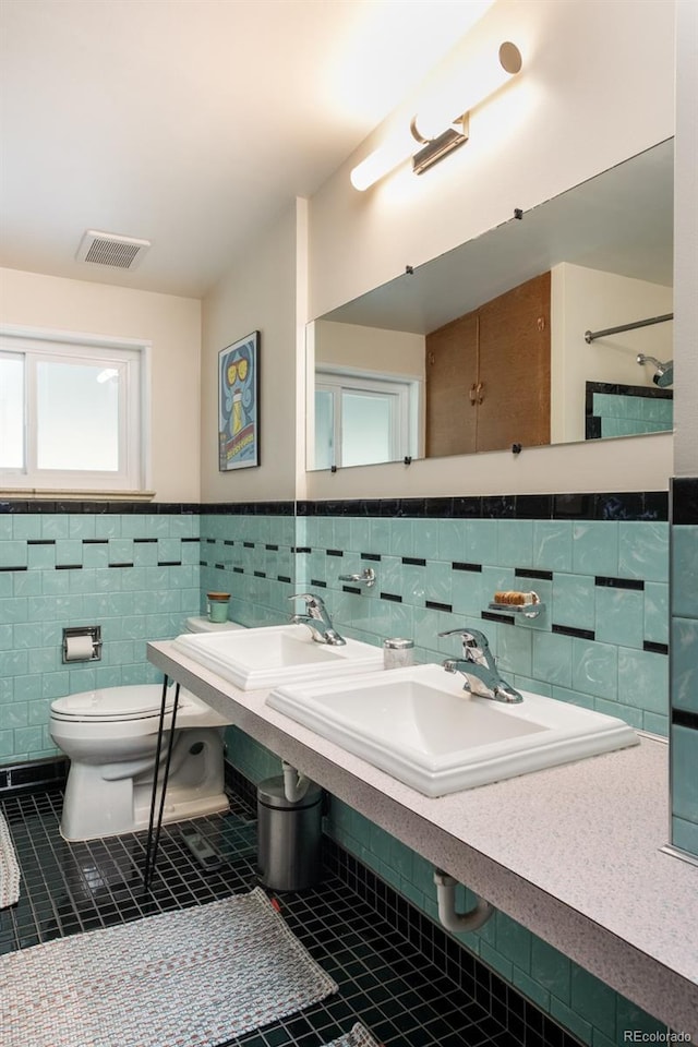 7820 Grove St, Westminster, CO 80030 - bathroom with tile patterned floors, tile walls, and a wainscoted wall