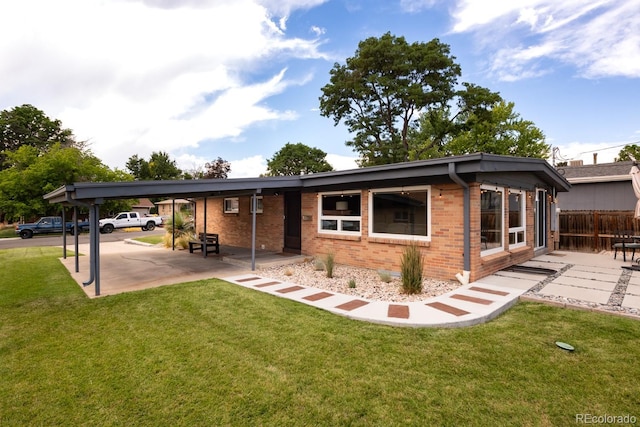 7820 Grove St, Westminster, CO 80030 - view of front of property with brick siding, a carport, and a patio area