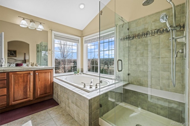 full bath featuring tile patterned flooring, vaulted ceiling, and a shower stall