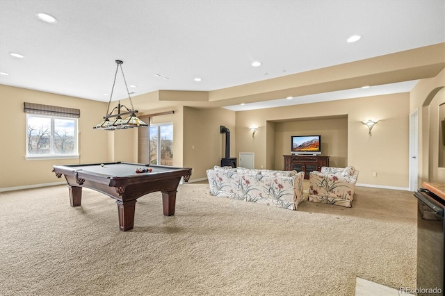 game room with carpet floors, recessed lighting, a wood stove, and baseboards