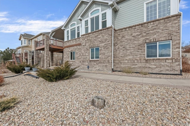 rear view of house with brick siding