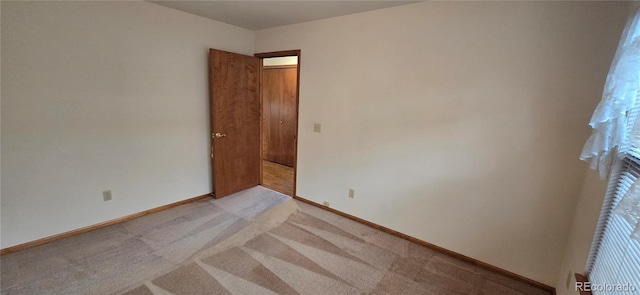 spare room with light colored carpet