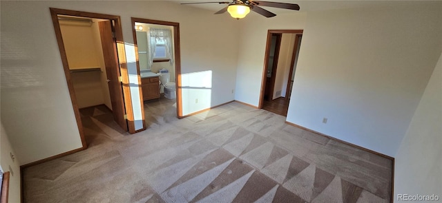 empty room featuring light carpet and ceiling fan