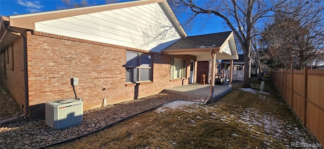 view of side of property with central air condition unit and a patio