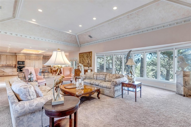 living room with ornamental molding, lofted ceiling, light colored carpet, and a raised ceiling