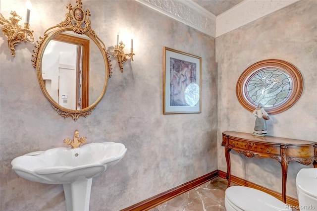 half bathroom with marble finish floor, toilet, and baseboards