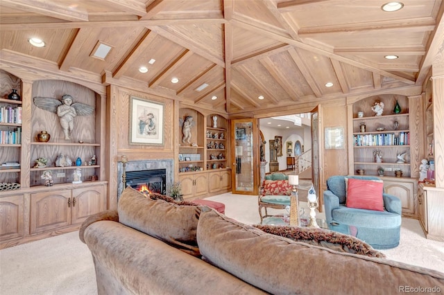 carpeted living room featuring built in shelves, a premium fireplace, and beam ceiling