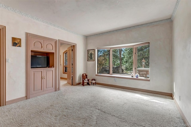 empty room featuring carpet floors and baseboards