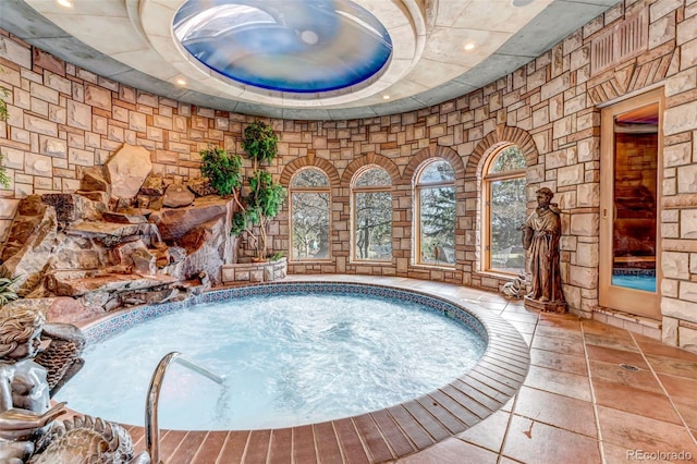 view of swimming pool featuring an indoor in ground hot tub