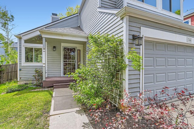 744 Owl Dr, Louisville, CO 80027 - property entrance featuring a chimney and an attached garage