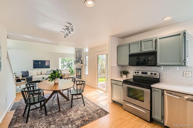 744 Owl Dr, Louisville, CO 80027 - kitchen with appliances with stainless steel finishes, light countertops, tasteful backsplash, light wood-style floors, and recessed lighting