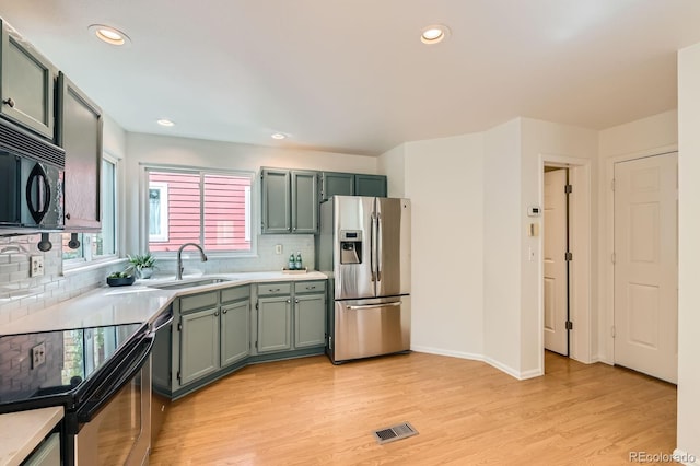744 Owl Dr, Louisville, CO 80027 - kitchen featuring stainless steel refrigerator with ice dispenser, a sink, electric range oven, black microwave, and light countertops