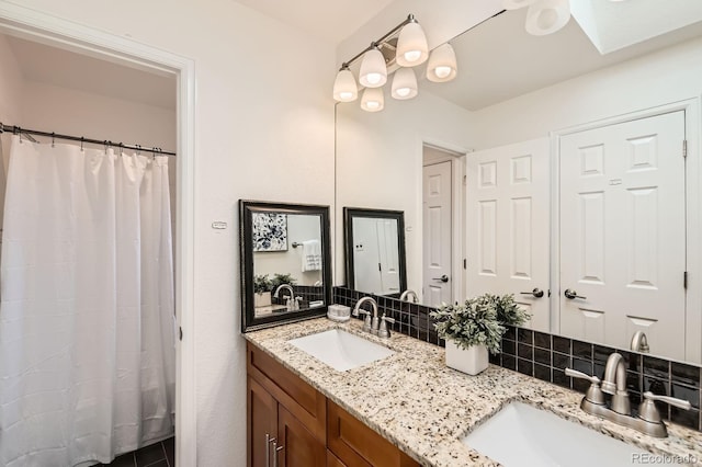 744 Owl Dr, Louisville, CO 80027 - full bath featuring tasteful backsplash, double vanity, curtained shower, and a skylight