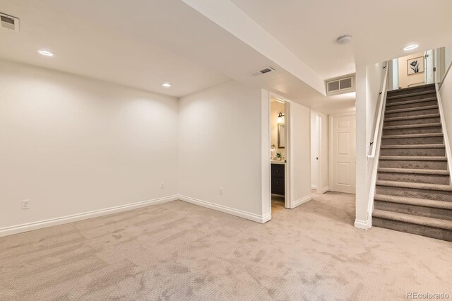 744 Owl Dr, Louisville, CO 80027 - below grade area with light colored carpet, stairway, baseboards, and recessed lighting