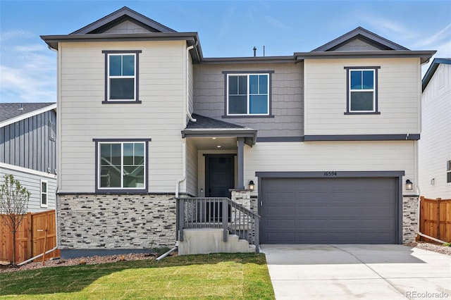 view of front of house featuring a garage, a front yard, concrete driveway, and fence
