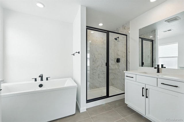 bathroom featuring vanity, a marble finish shower, tile patterned flooring, and visible vents