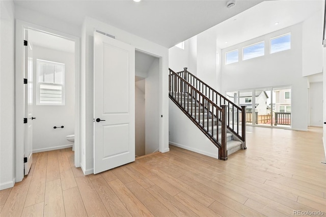 stairs featuring wood finished floors and baseboards