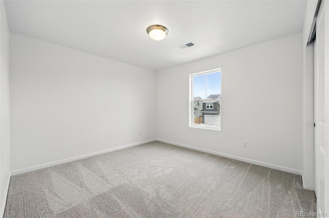 unfurnished bedroom featuring carpet, visible vents, and baseboards