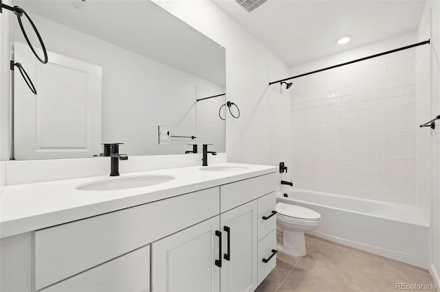 bathroom with toilet, tile patterned flooring, a sink, and double vanity