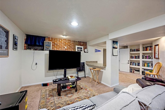 carpeted living area with built in shelves, baseboards, and a textured ceiling