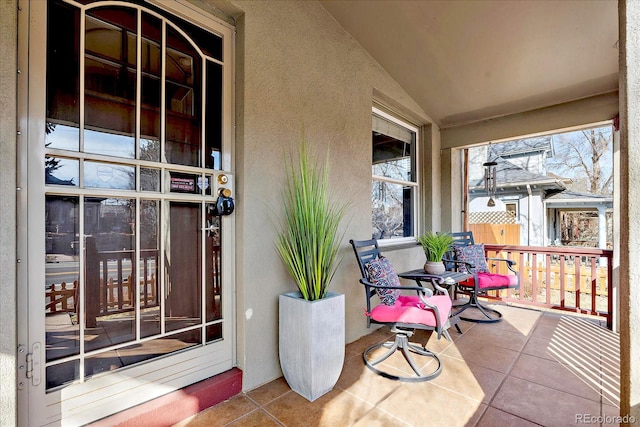 doorway to property with stucco siding and a porch