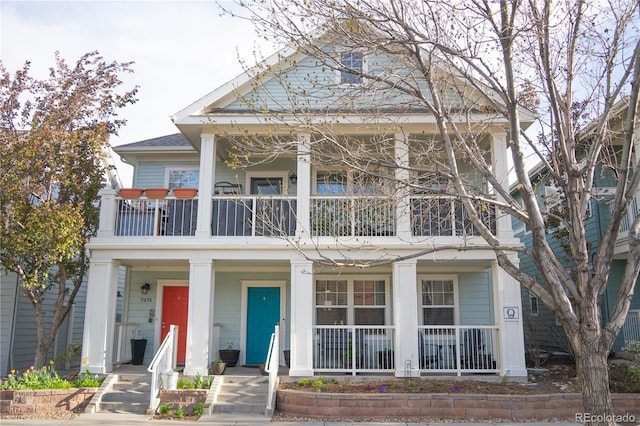 greek revival inspired property with a porch and a balcony