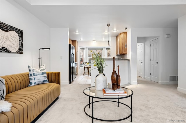 living room featuring light carpet and baseboards