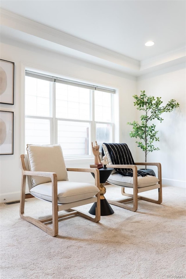 sitting room with baseboards, carpet, and crown molding