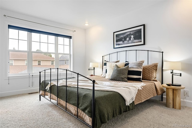 bedroom featuring carpet floors and baseboards