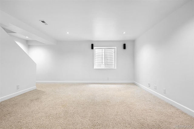 spare room featuring carpet, baseboards, and recessed lighting