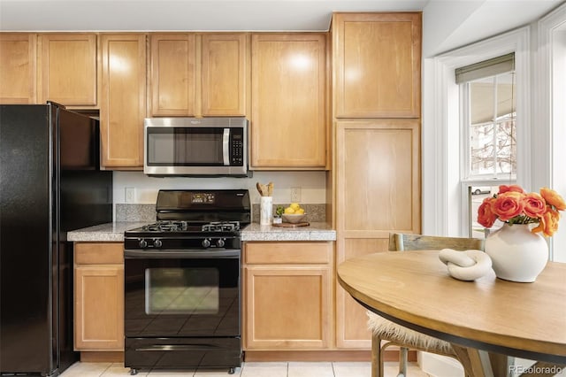 4395 E Jewell Ave Unit 3, Denver, CO 80222 - kitchen with black appliances, light tile patterned floors, and tile countertops