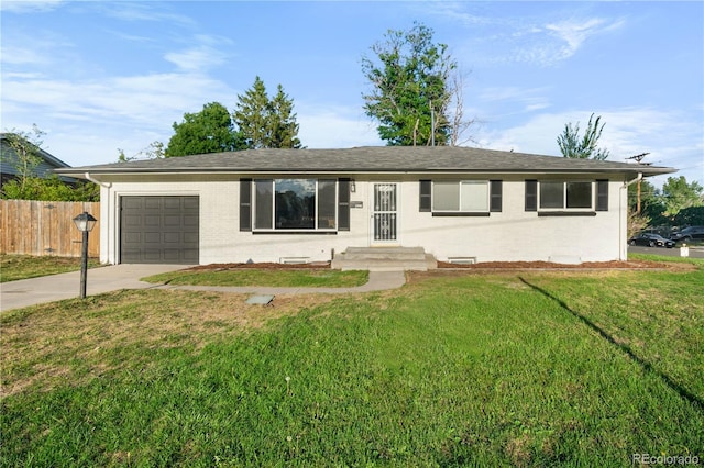 ranch-style house with a garage and a front lawn