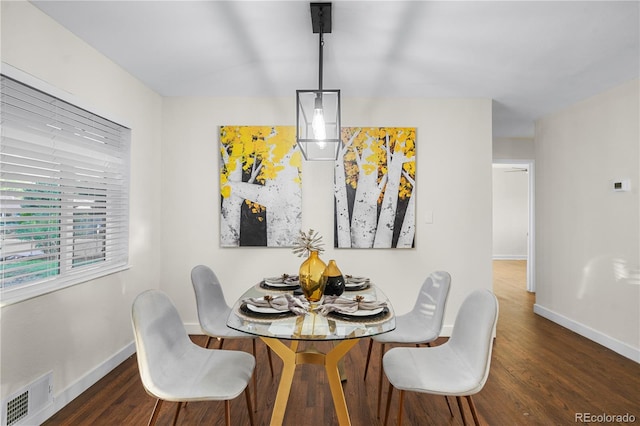 dining area with dark hardwood / wood-style flooring