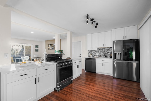 kitchen with black dishwasher, dark hardwood / wood-style floors, white cabinetry, stainless steel fridge, and range with gas cooktop