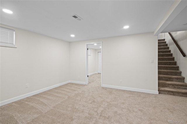 basement featuring light colored carpet